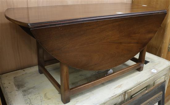 A George III style mahogany circular drop leaf low table, W.125cm